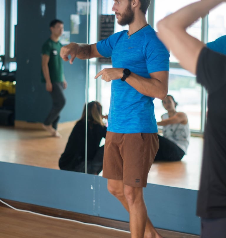 a man in a blue shirt is coaching movement