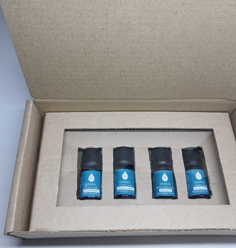 A set of four Cedral 100% pure essential oil bottles in a cardboard gift box for aromatherapy.