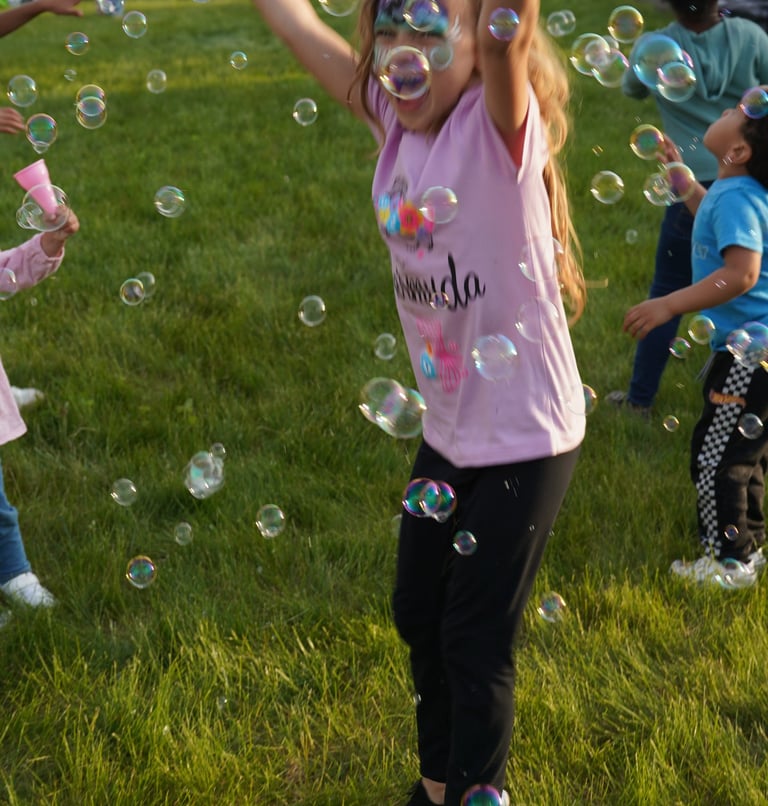 Young girl plays in bubbles