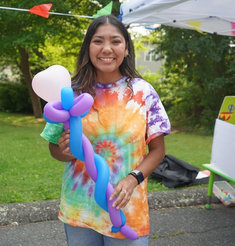Kid posing with baloon staff