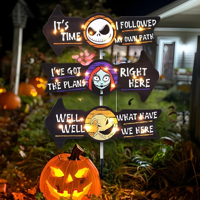 Halloween yard decoration featuring three illuminated arrow signs with characters from The Nightmare