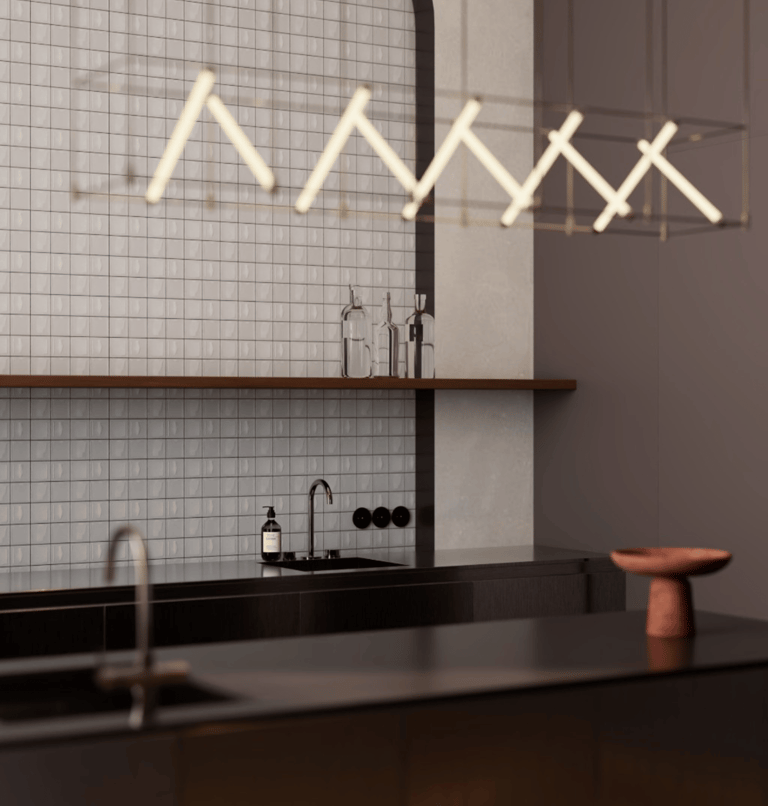 Contemporary kitchen design featuring a dark countertop and illuminated by a linear light fixture.