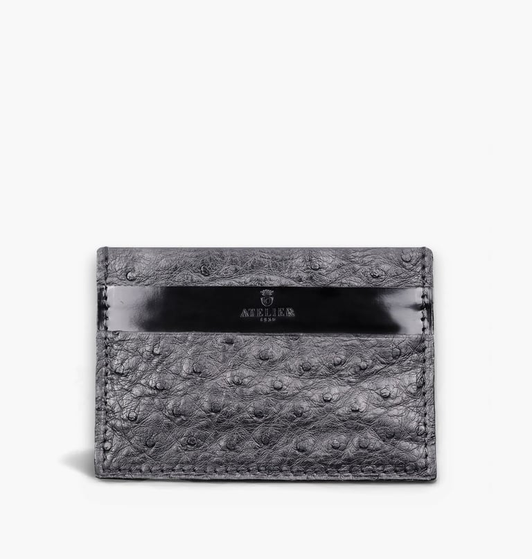 Luxury grey ostrich leather card holder featuring a black accent strip and Atelier logo.