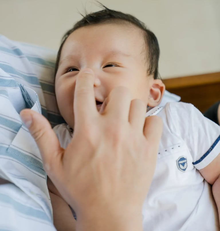 Close-up portrait of a smiling baby at Samabe Bali Suites & Villas in Nusa Dua.