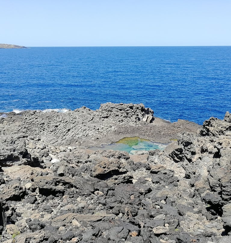 Laghetto delle Ondine in Pantelleria, natural saltwater pool among volcanic rocks and sea