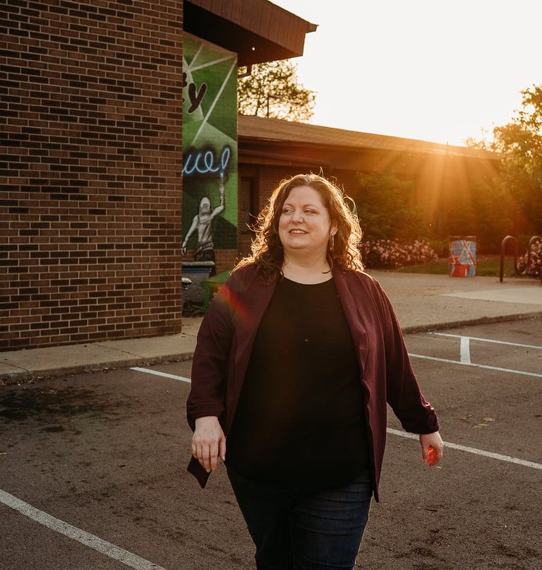 Confident woman walking with community center in background