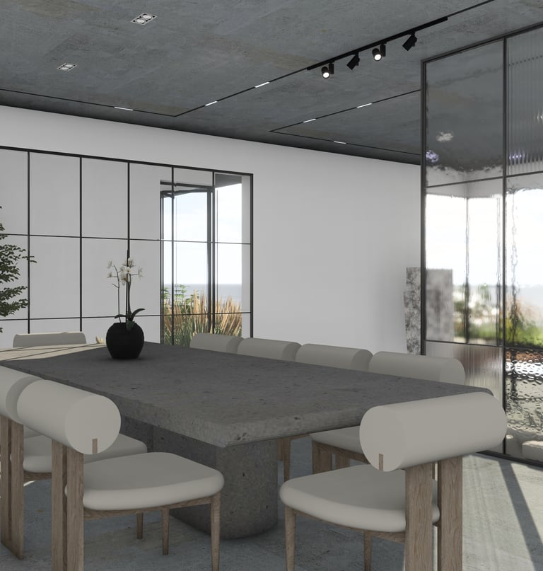 Large concrete dining table and modern chairs with light upholstery illuminated by track lighting