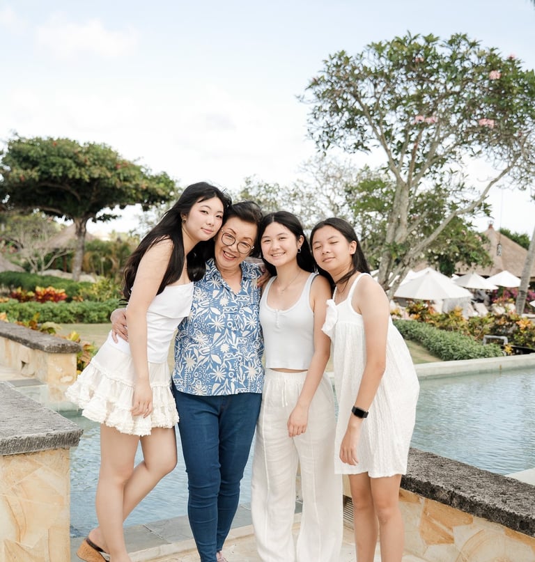 Three sisters walking together naturally during a relaxed family photography session at Ayana Jimbaran Bali