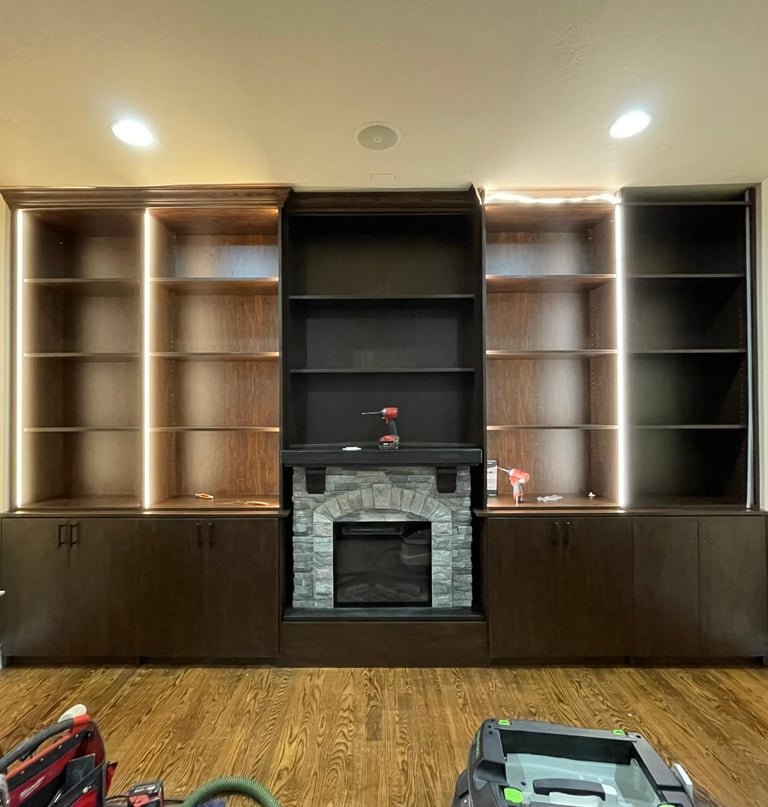 Living room custom bookcase with fireplace by Portugal Woodworks in Utah, elegant and functional.