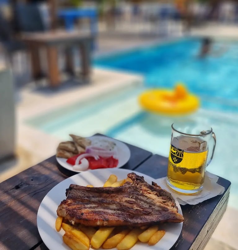 a plate of food and a beer on a table