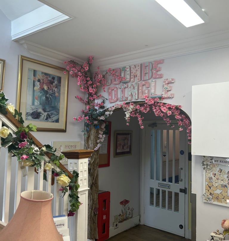 bright entrance hall with flowers along the stairs