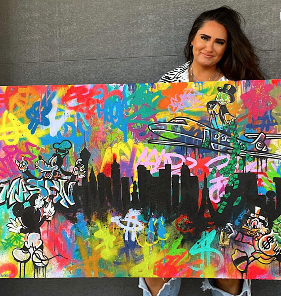 Kamile with her graffiti character painting