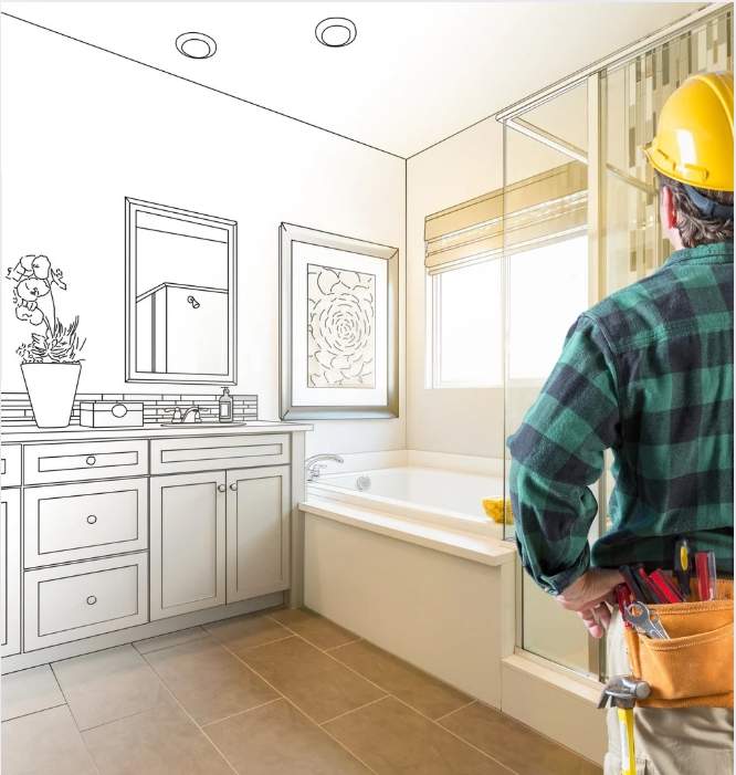 Construction worker wearing a hard hat reviewing a bathroom remodel design.
