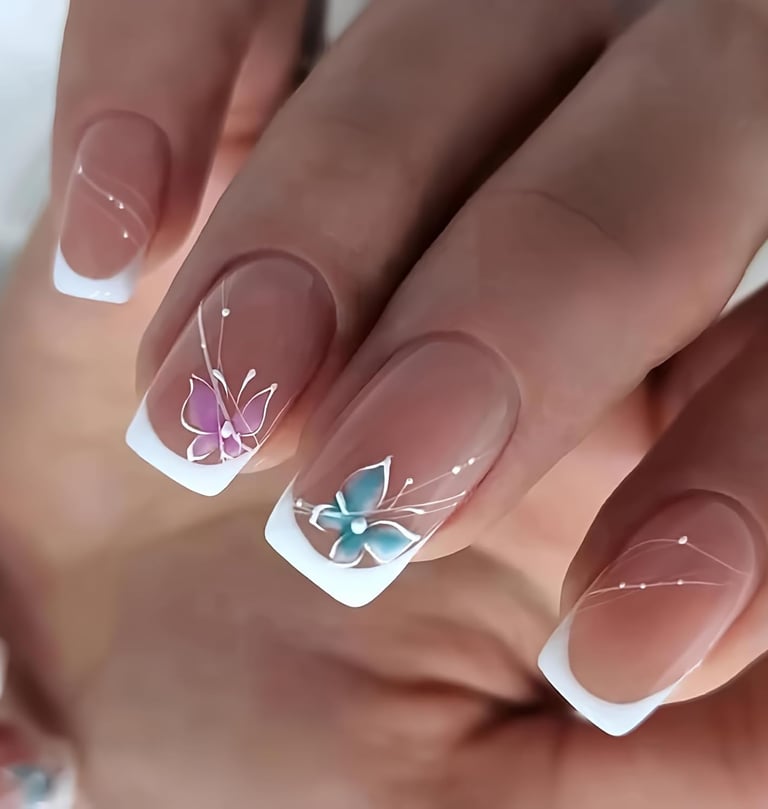 a woman's hand painted nails with a butterfly on her nails