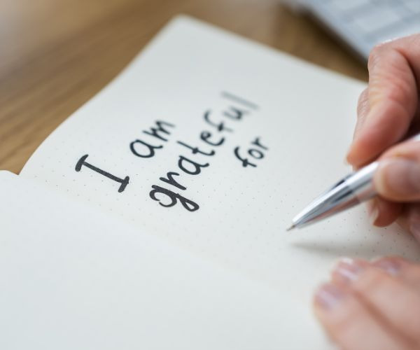 a person writing a notepad with a pen