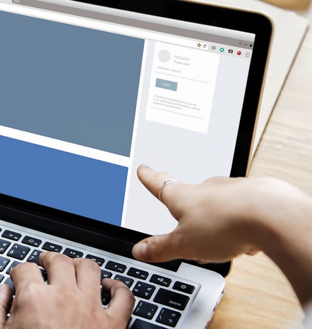 a person is typing on a laptop computer screen