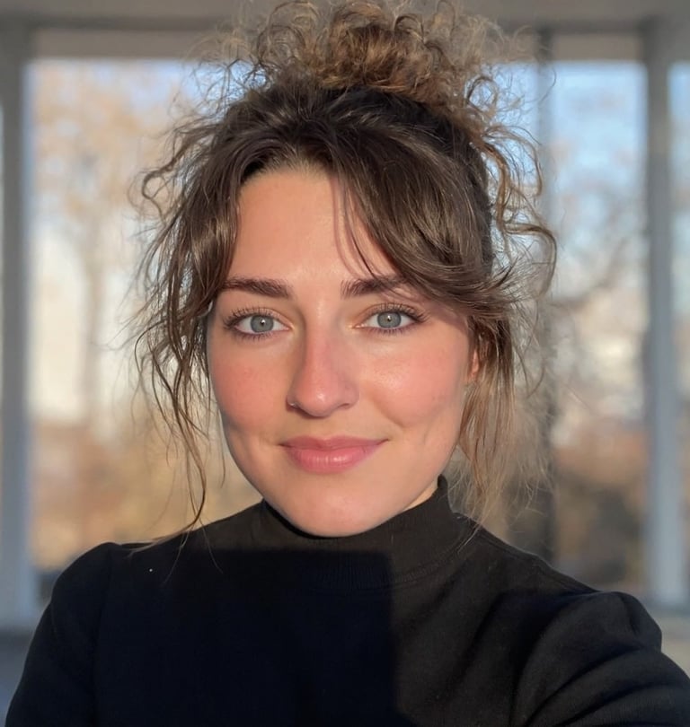 A selfie of a woman with a messy bun