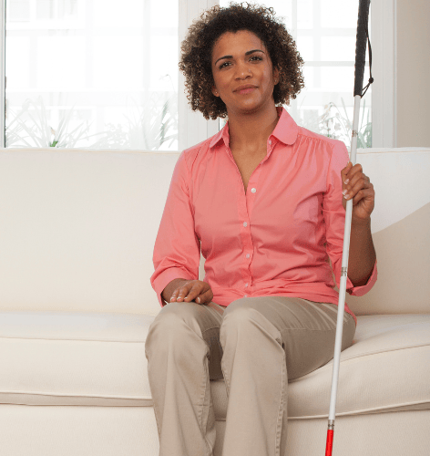 Professional woman with astigmatism and cane for the blind