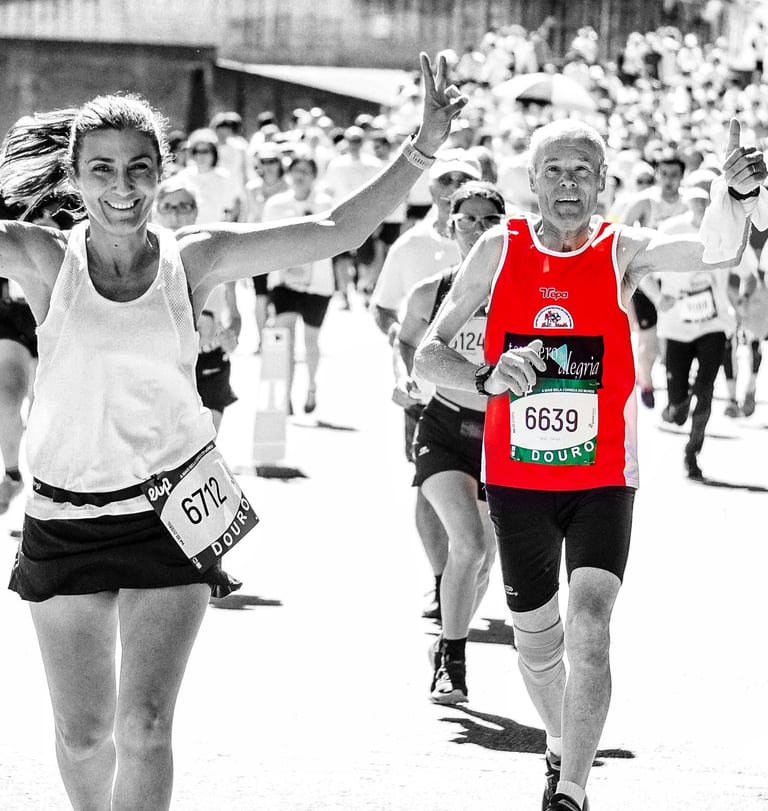 a woman and an old man running in a marathon race