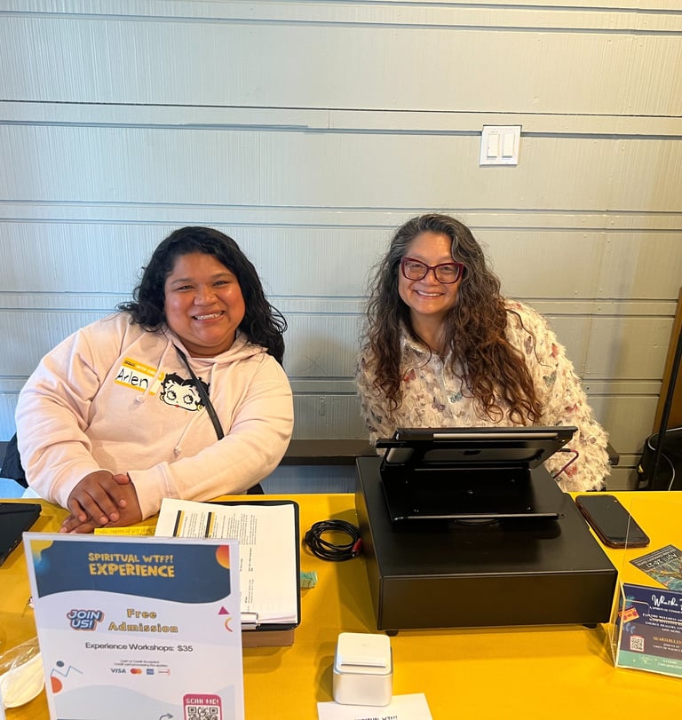 Volunteers helping check in guest at Spiritual WTF?! Experience.
