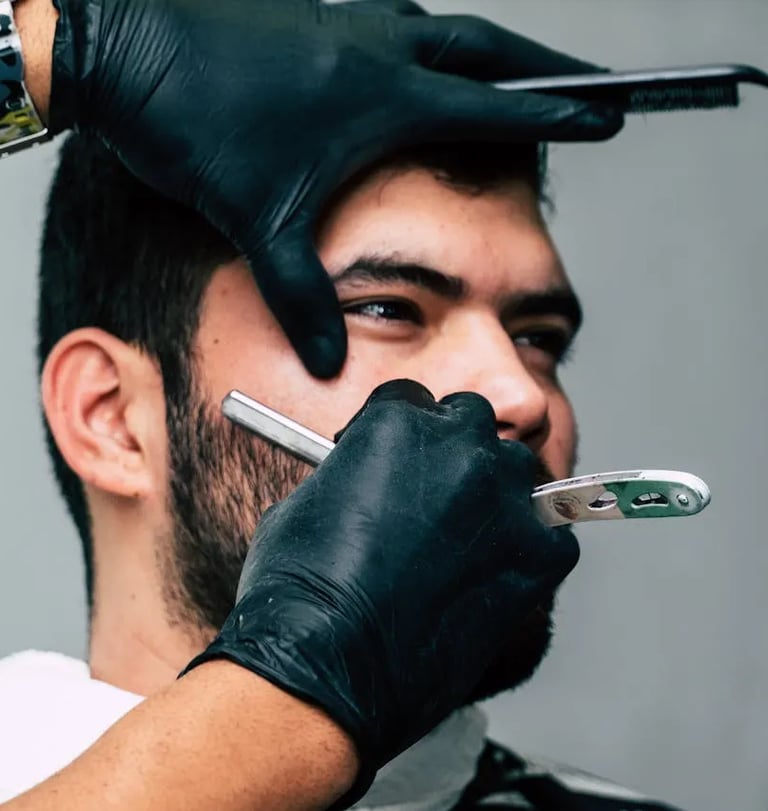 a man with a beard and gloves on his head