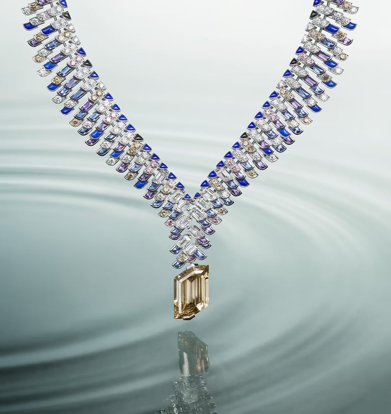 Cartier sapphire and diamond necklace with a striking water reflection.