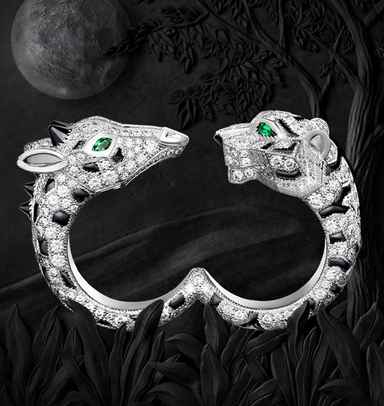 Cartier diamond panther bracelet with emerald eyes.