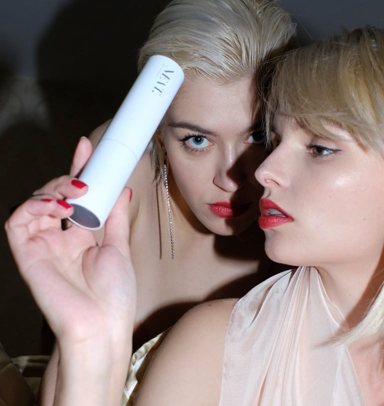 two women in evening wear, one is holding ALL YOU NEAT.´s Ultimate Age Defense Face Cream