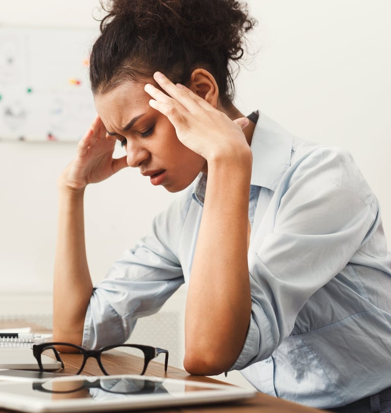Woman holding head and looking frustrated