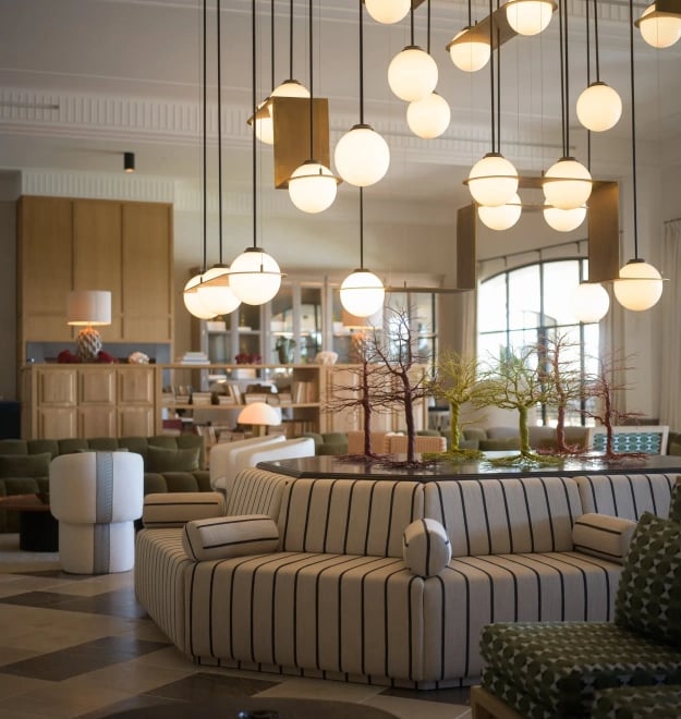 Main salon at Villa La Gratitud with sculptural lighting and striped circular sofa