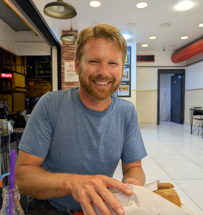 don holding a Kokorec sandwich from  Mis kokorec Kemeralti in Izmir, Turkey
