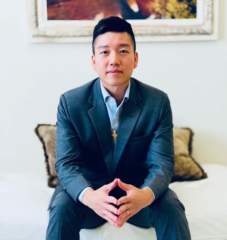 a man in a suit and tie sitting on a couch