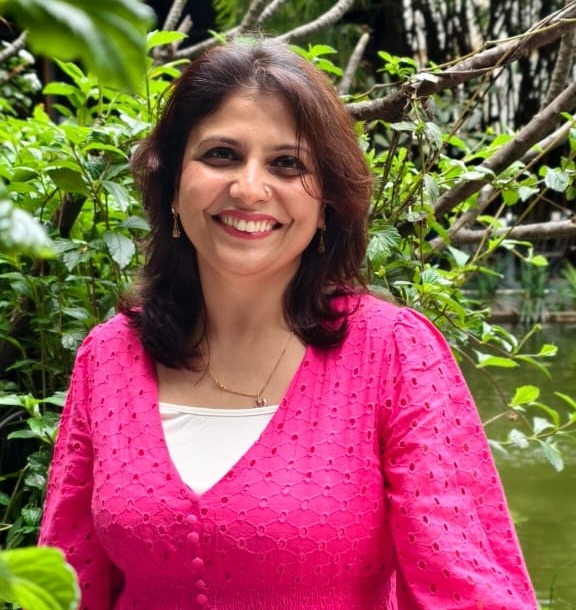 image of Shruti Pushkarna smiling at the camera wearing pink