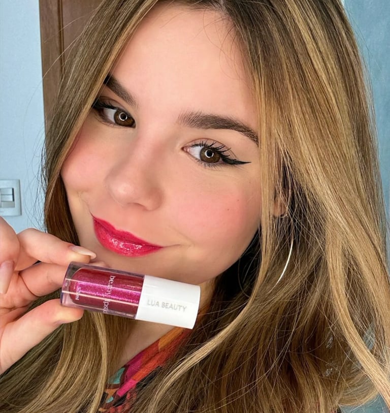 a woman with long hair and a pink lipstick