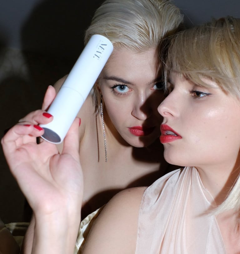 two women in evening wear, one is holding ALL YOU NEAT.´s Ultimate Age Defense Face Cream