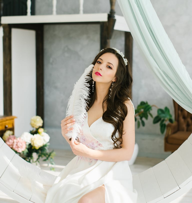 a woman in a white dress sitting on a circular object