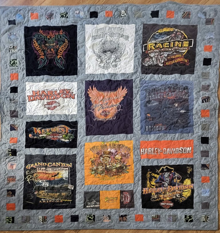 T-shirt memory quilt made from printed shirts arranged in quilt blocks.