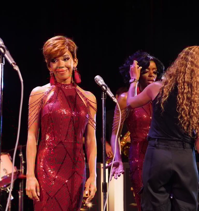 a woman in a red dress standing in front of a microphone