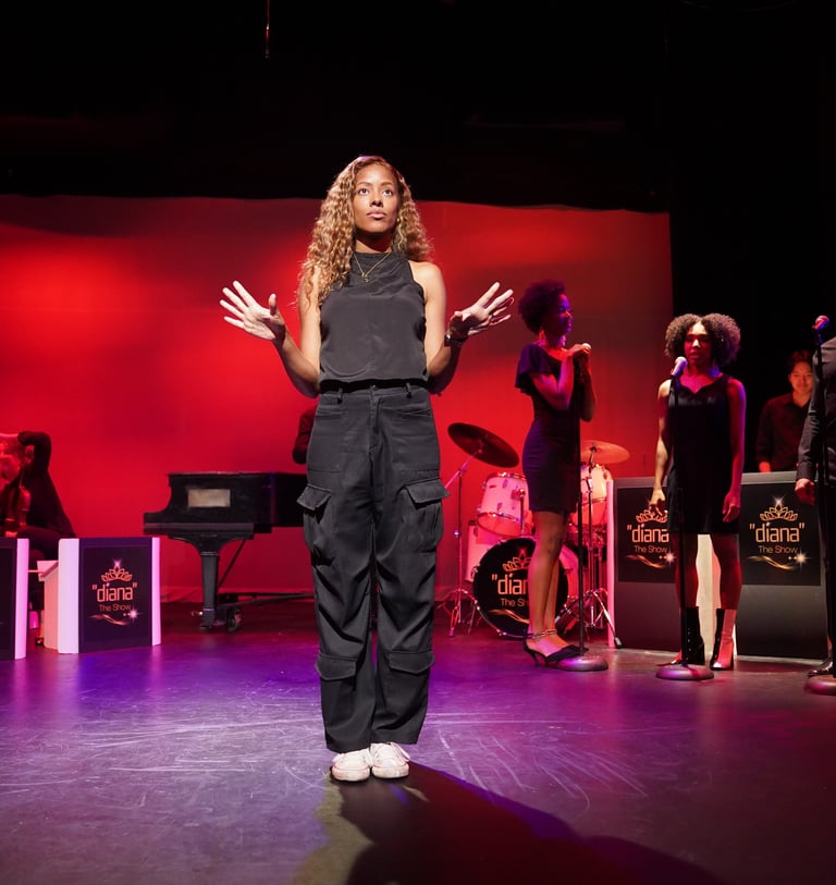 a woman in a black jumpsuit and a man in a black suit