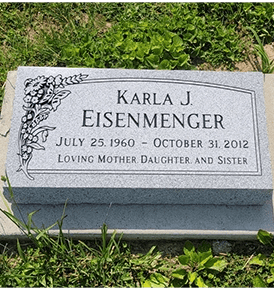 flat gravestone in georgia gray granite with carved butterfly
