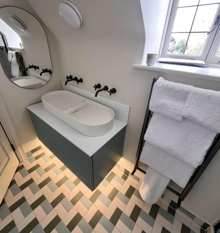 Elegant bathroom renovation with corner shower and chrome fixtures in Evesham Ask ChatGPT