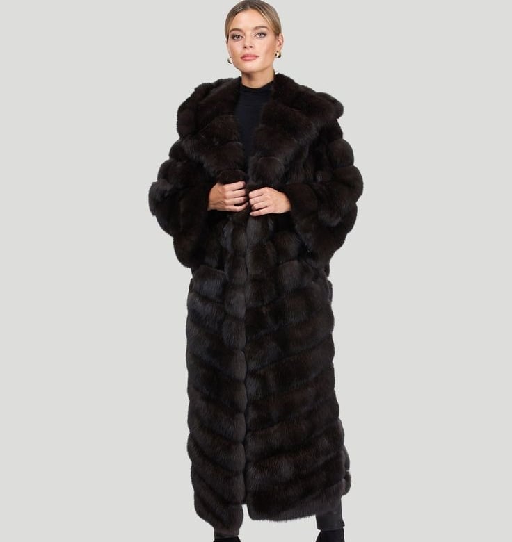 a woman in a long black gorski coat with a long coat