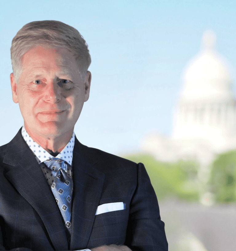Arkansas Criminal Defense Attorney Gene Ludwig poses in front of the Arkansas Capitol building. 
