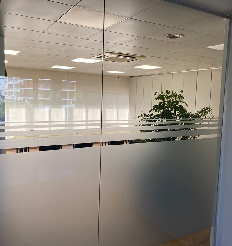 a glass door with a plant in the middle