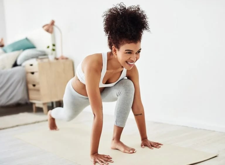 a woman in a sports bra top doing push ups