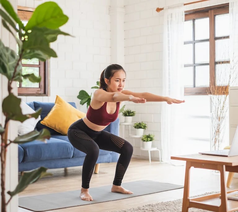 a woman doing yoga exercises on a yoga mat