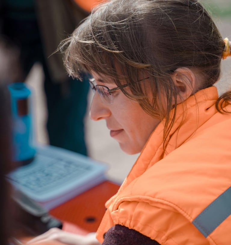Staff member focused on details while work stacks up
