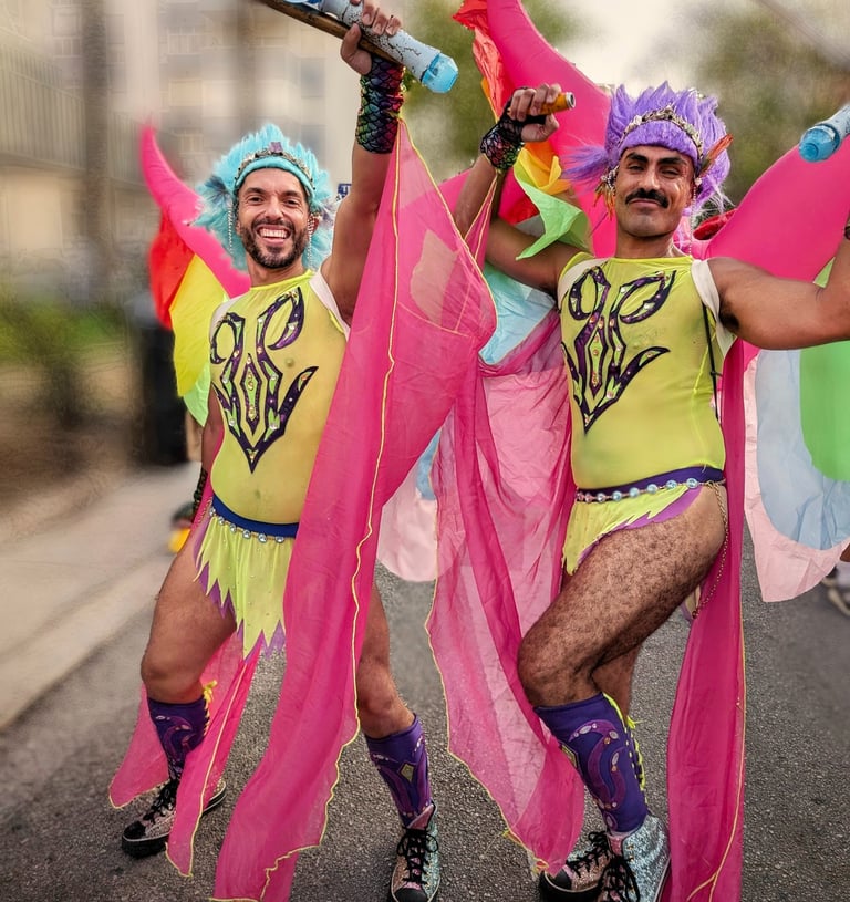 two men in colorful costumes are dancing in the street