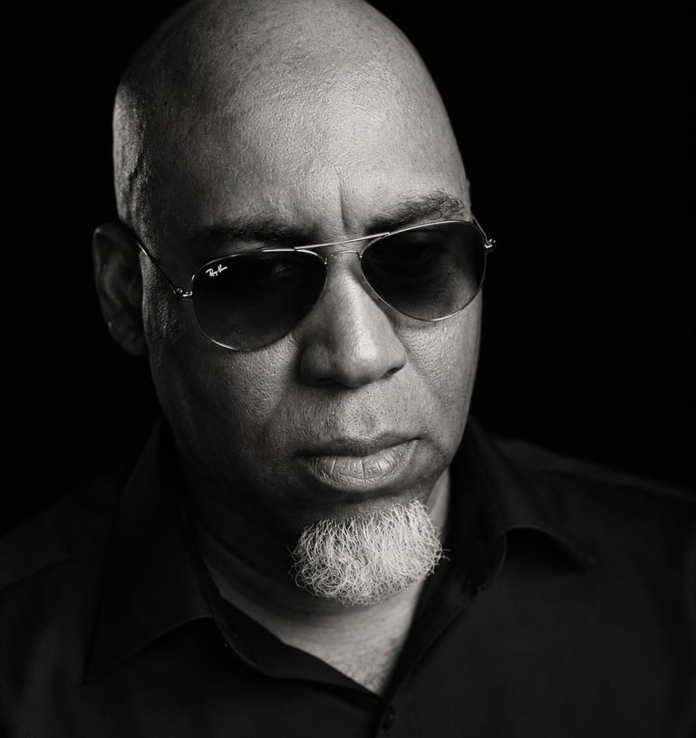 Lee A Jones host of Hindsight the Podcast in black and white wearing sunglasses