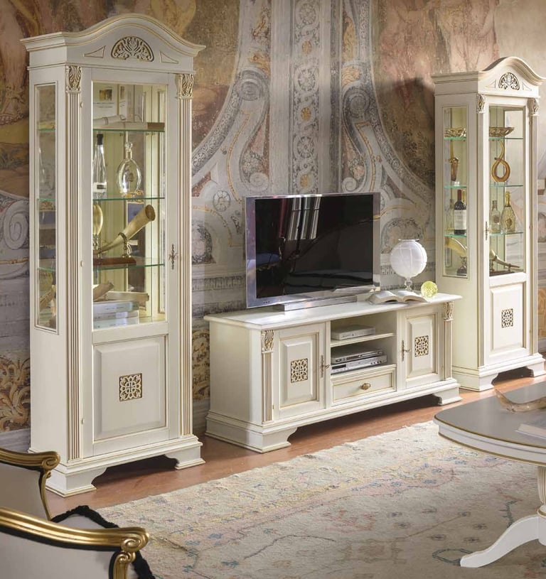 Classic white wooden TV stand and glass display cabinets with gold accents in a luxury living room.